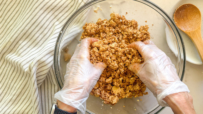 hands mixing tofu in bowl