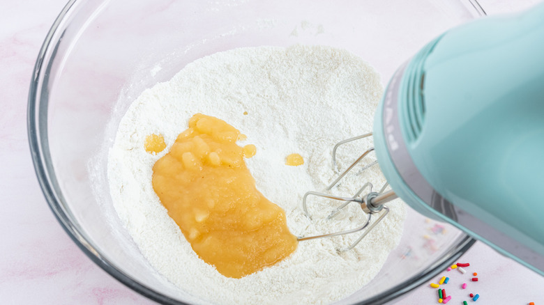 mixing applesauce into dry ingredients 