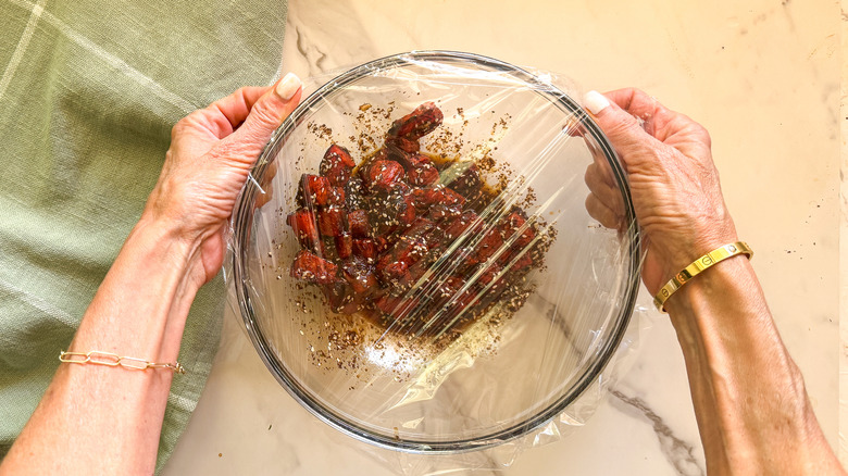 hands covering glass bowl