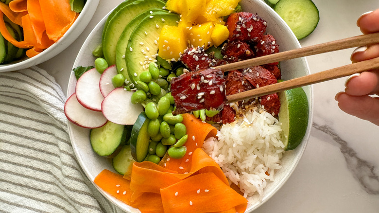 chopsticks holding watermelon piece