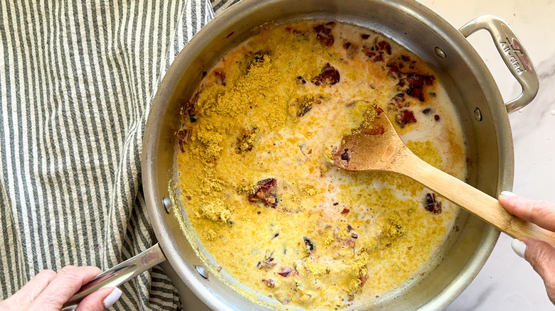 stirring pan with pasta sauce ingredients