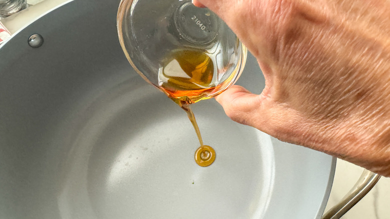 adding sesame oil to pot