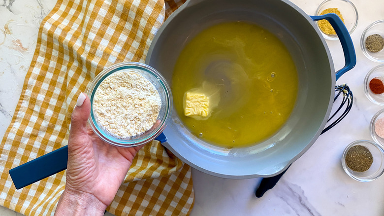 adding flour to pan