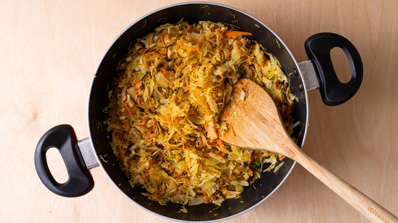 cooked cabbage and carrots in saucepan