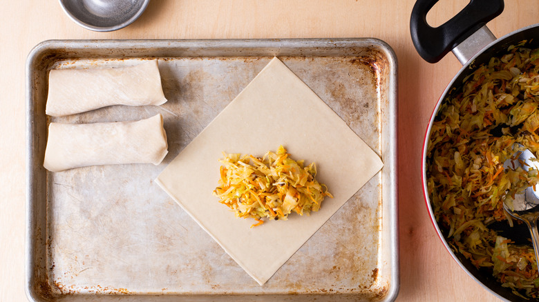 adding filling to egg roll