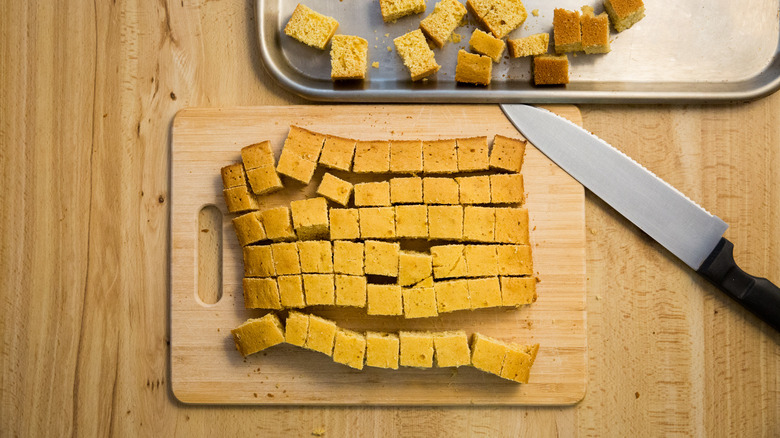 cubed cornbread on wooden board