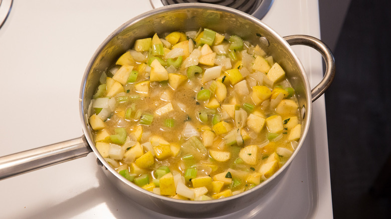 vegetables in broth on stove