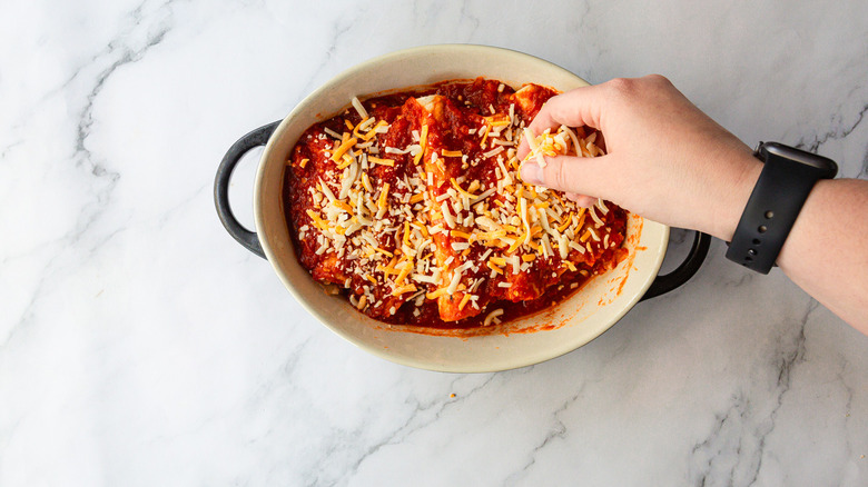 Topping enchiladas with cheese