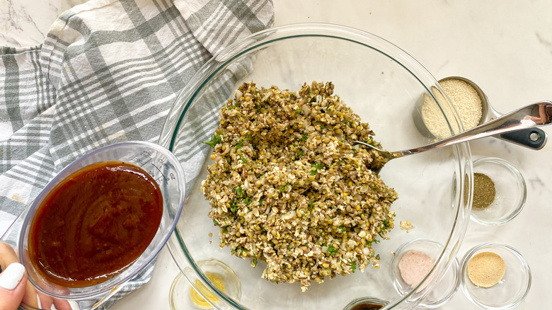 adding bbq sauce to bowl