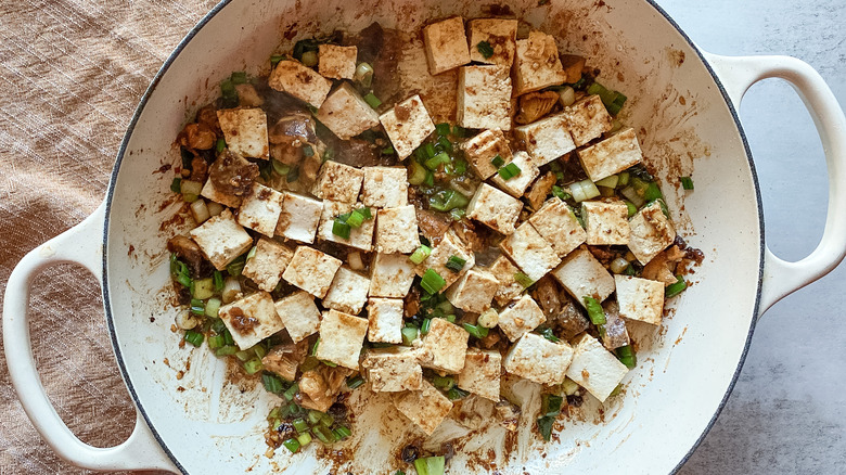 tofu, green onions in sauce in pot