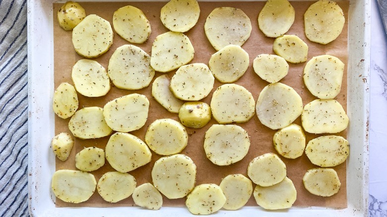 cut potatoes on baking sheet