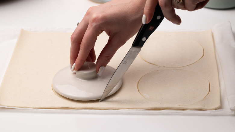 cutting out puff pastry lids 