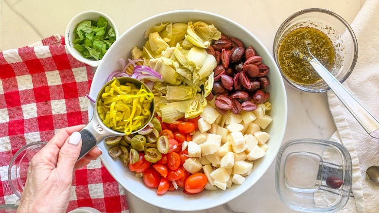 assembling salad in bowl 