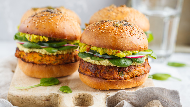 two veggie burgeres on a wood cutting board