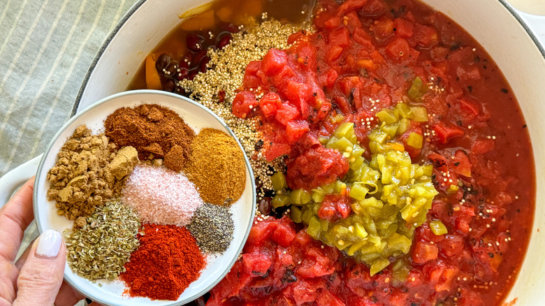 adding spices to pot