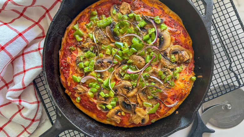 skillet with pizza on rack