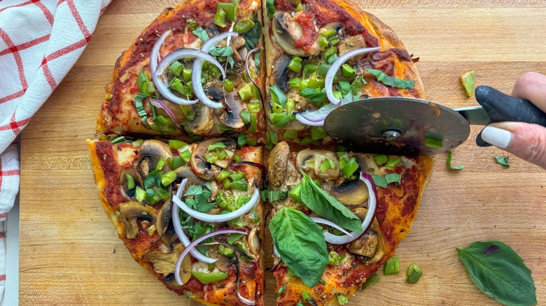 slicing the pizza with cutter