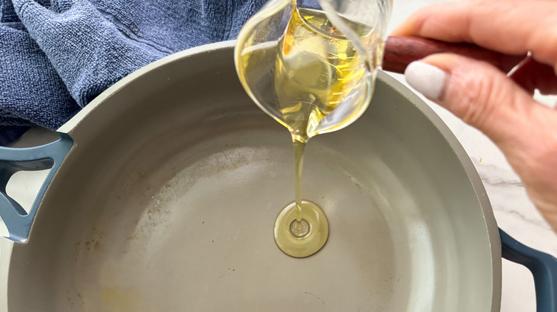 adding oil to a pan