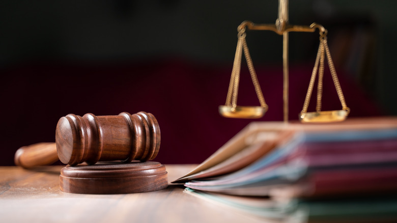 Gavel on a table and small scales