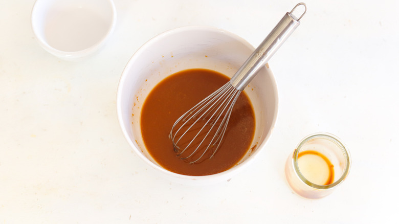 chicken marinade in a bowl with whisk