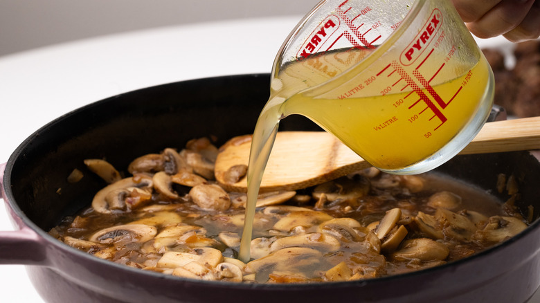 Pouring stock into a pan