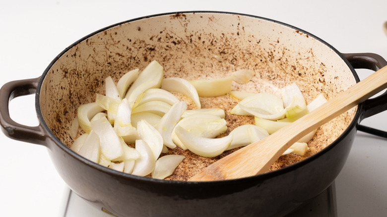 sautéing onions in a pan