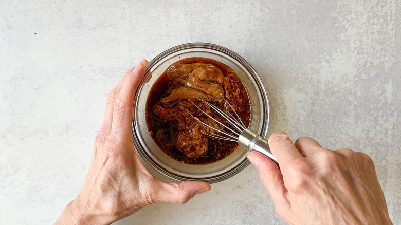 whisking sauce in bowl