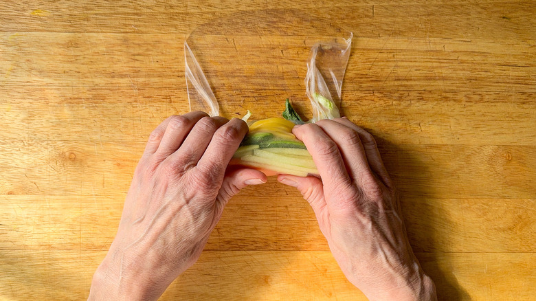 hands folding summer roll