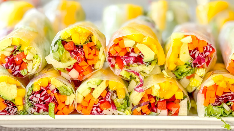 Vibrant rainbow summer rolls on platter