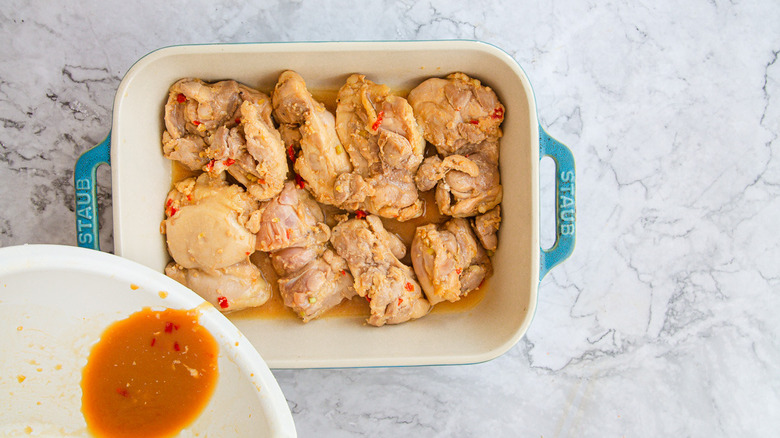 Adding marinade to baking dish