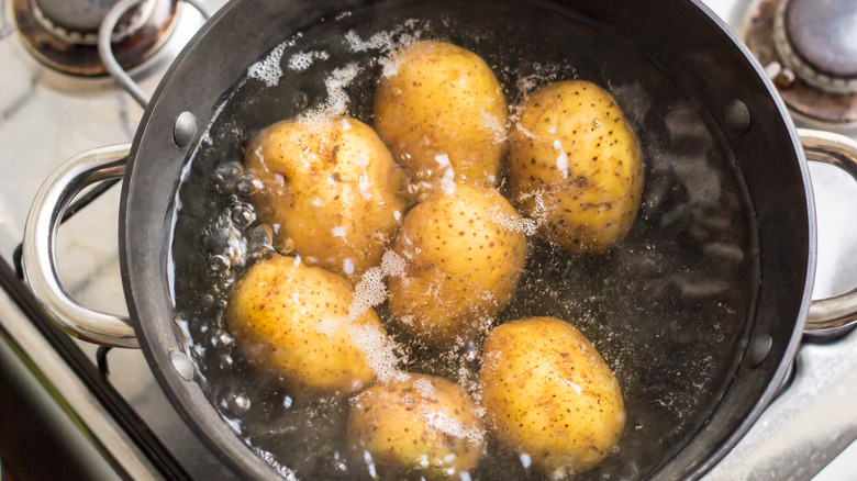 Potatoes boiling in pot