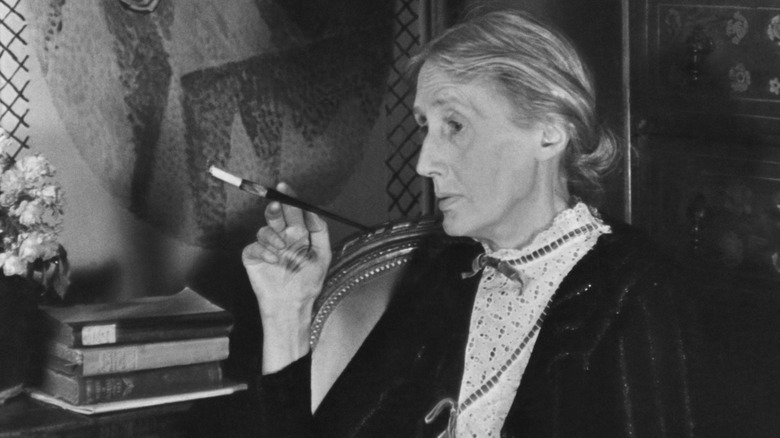 Virginia Woolf, seated with cigarette