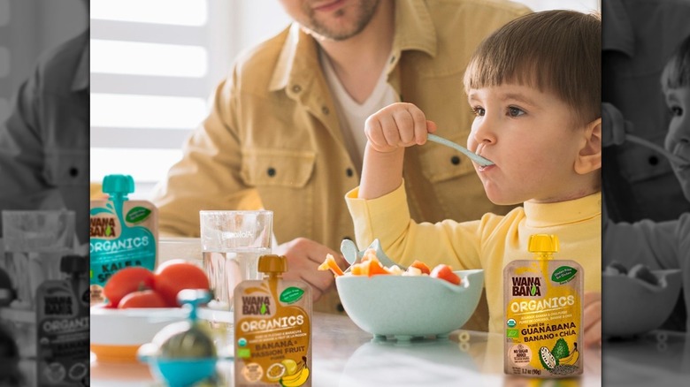 Toddler eating fruit in a WanaBana ad