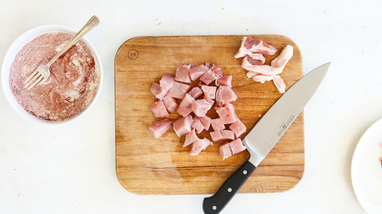 cut up pork chops on a cutting board