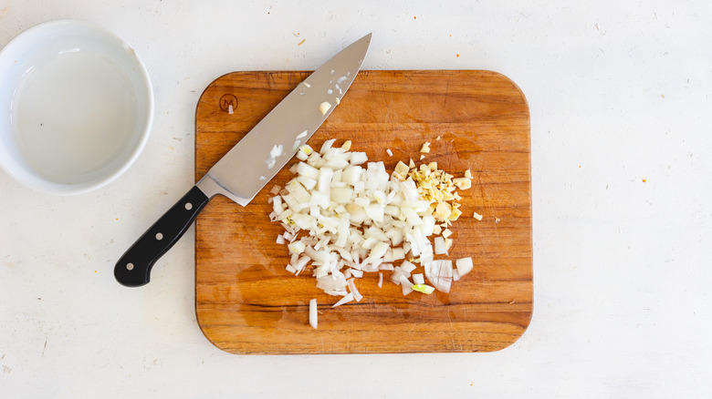 diced onion and garlic on cutting board