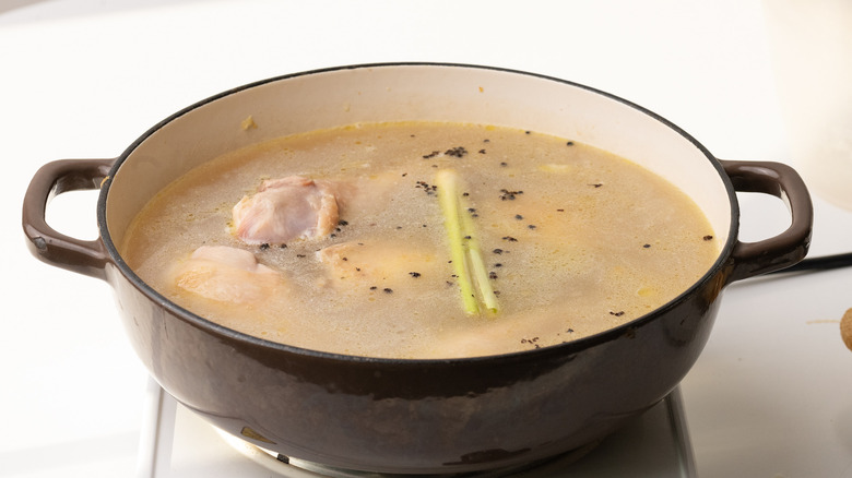 chicken tinola simmering in pan