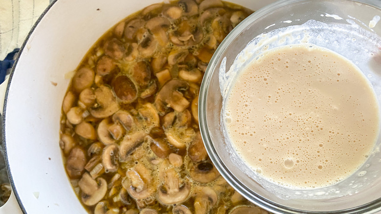 adding milk mixture to pot of Hungarian soup