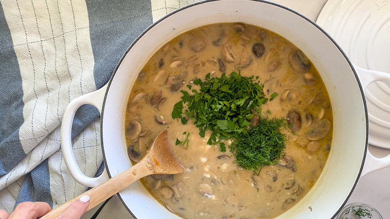 parsley and dill in pot of soup