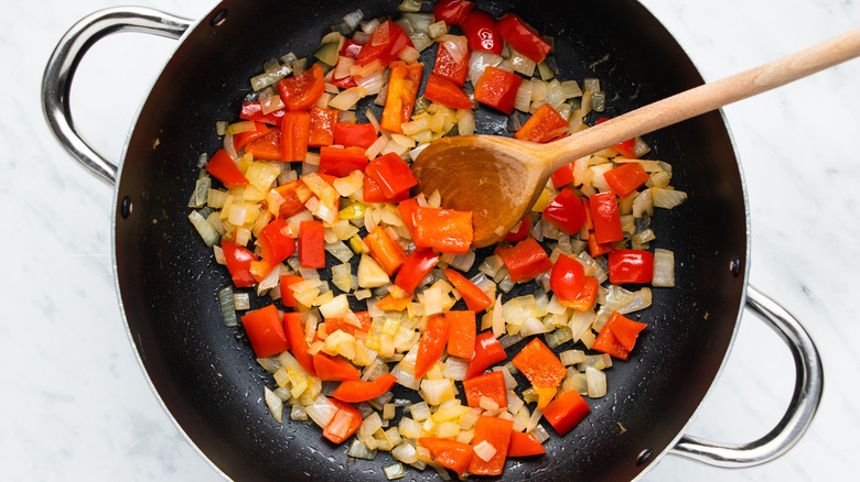 onion and pepper in frying pan 