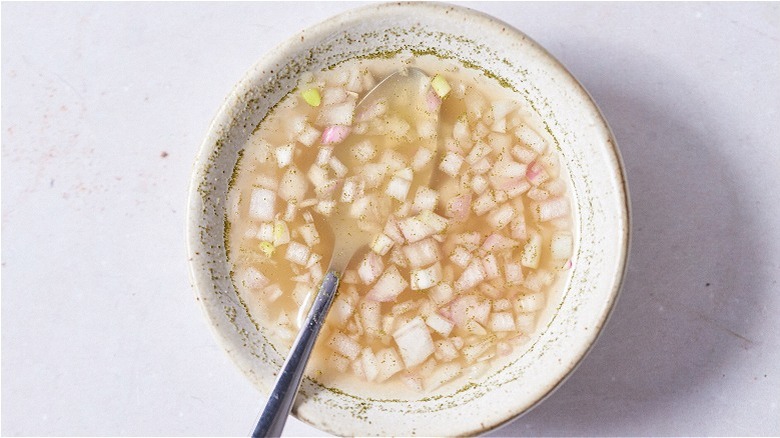 mignonette with spoon in bowl