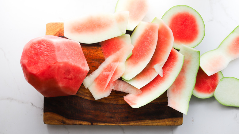 Watermelon rind removed on board