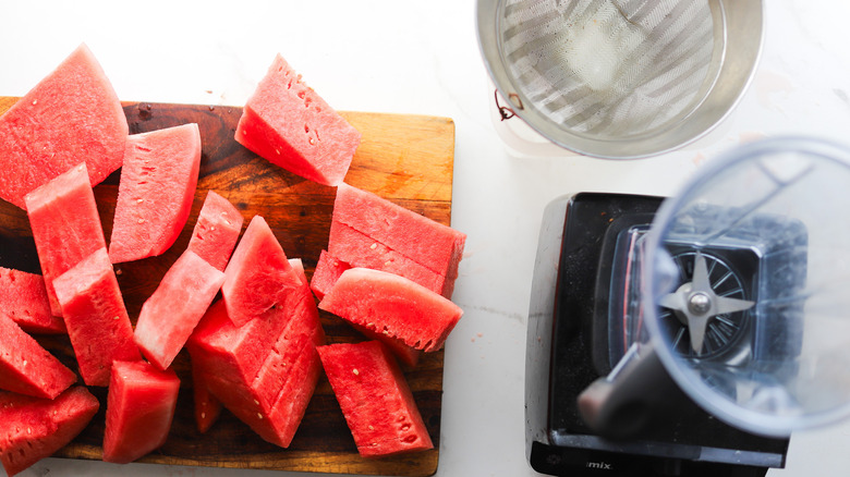 Cut watermelon near blender