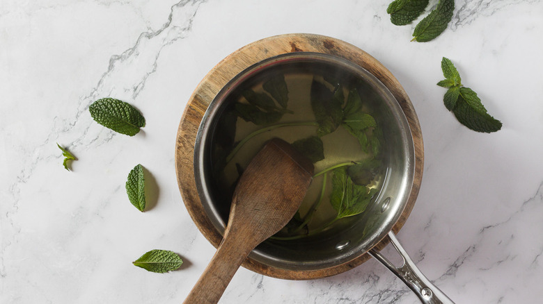 Mint simple syrup in a saucepan