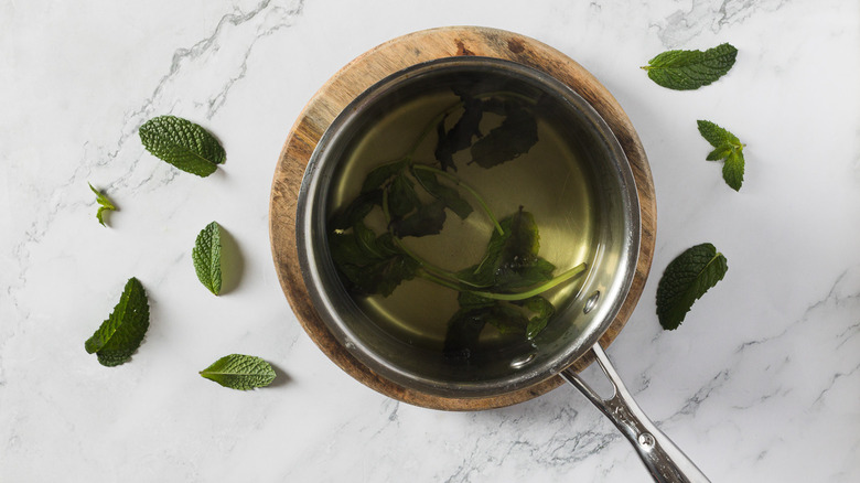 Mint simple syrup in a saucepan