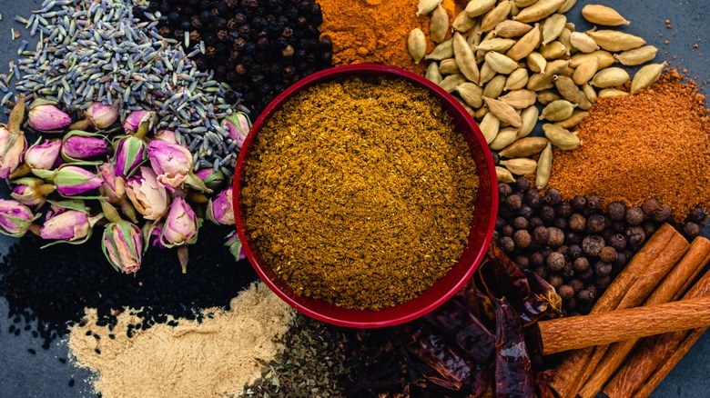 A spice mix surrounded by its ingredients