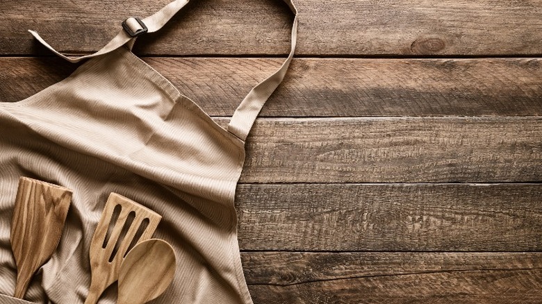 apron and utensils on board