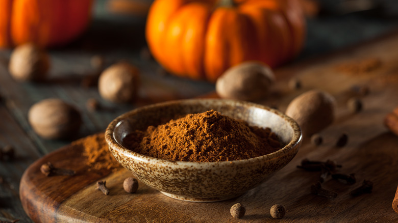 Bowl of brown spices with pumpkin