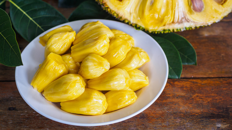 pieces of jackfruit next to an opened one