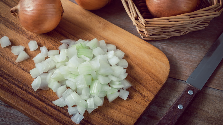 Chopped onion on cutting board 