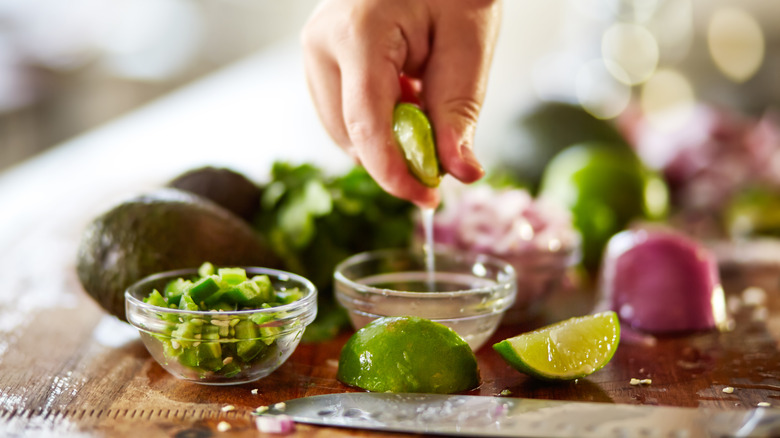 Hands making guacamole 